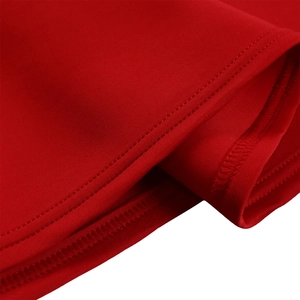 Macro detail of red dress showing premium double-needle stitching and fabric texture