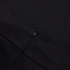 Close-up of the invisible zipper and fine horizontal texture on black sleeveless top
