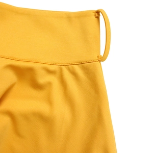 Detail of a bright yellow waist design with belt loops on a high-waisted elastic skirt