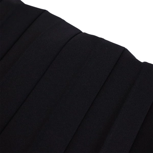 Detailed macro view of black pleated fabric with fine texture and vertical accordion folds