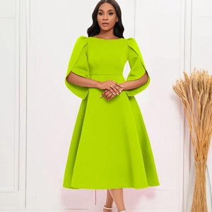 Detail of elegant lime green dress with pleated puff sleeves and flared skirt silhouette