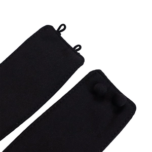 Close-up of black twill fabric belt with covered buttons and elastic loops detailing