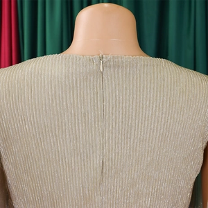 Close-up of the invisible back zipper on a champagne pleated v-neck cape dress