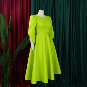 Detail of elegant lime green dress with split bell sleeves and high-density knit fabric