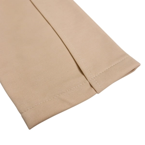 Detailed close-up of double-stitched hem on khaki fabric showing fine textile texture