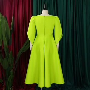 Detailed back view of neon green A-line dress with bubble sleeves and hidden zipper