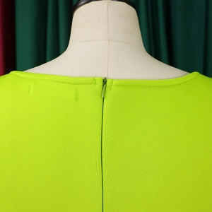 Close-up of fluorescent green dress back featuring an invisible zipper and neat stitching