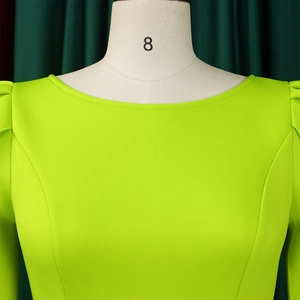 Close-up of lime green dress with puff sleeves and elegant princess seam detailing