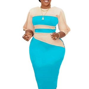 Detail of color block dress featuring blue and beige geometric panels and wide sleeves
