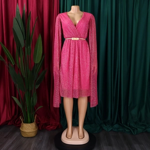 Detail of rose pink V-neck cape dress featuring shimmering fabric and gold chain belt