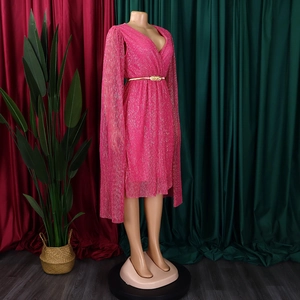 Detail of bright pink V-neck party dress with glitter fabric and cape sleeves