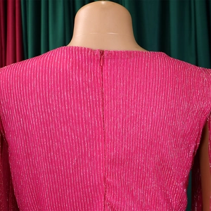 Detail of rose pink dress featuring fine pleated texture and hidden back zipper
