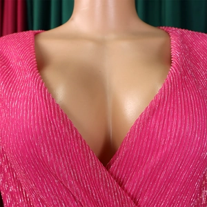 Detailed close-up of rose red V-neck dress featuring metallic pleated fabric and crossover design