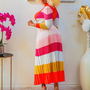 Detailed view of colorful pleated dress with vibrant stripes and rich textured fabric