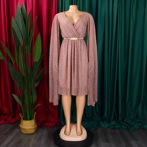 Detail of elegant pink V-neck cape dress with metallic pleated texture and gold belt