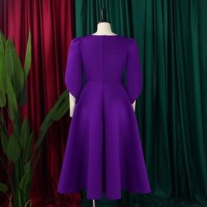 Detail of the back view of this deep purple long sleeve dress featuring hidden zipper closure