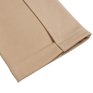 Macro shot of khaki dress cuff with precise white double stitching on smooth fabric