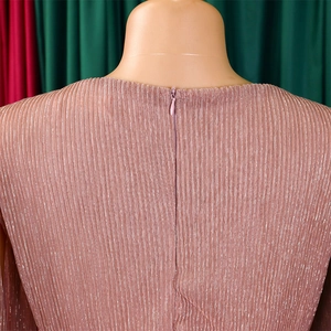 Detail of elegant pink pleated fabric with metallic shimmer and a hidden back zipper