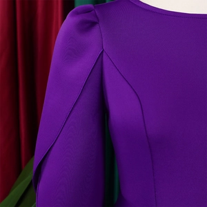 Close-up of elegant purple puff sleeve and shoulder tailoring on a formal evening dress