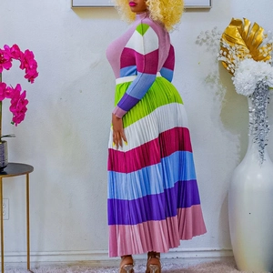 Detail of colorful pleated two-piece set featuring vibrant striped maxi skirt and knit top