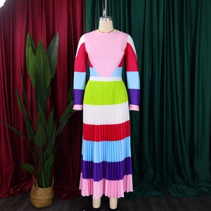 Close-up of vibrant pleated maxi dress with colorful patchwork and long sleeves