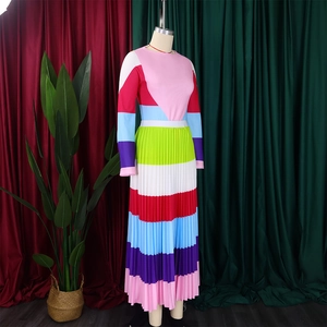 Detail showing colorful pleated skirt with vibrant rainbow stripes and textured fabric