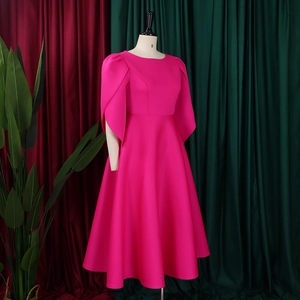 Detail of elegant fuchsia dress showing round neck, puff sleeves, and high waist fabric texture