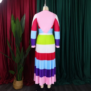 Detail of colorful pleated fabric and vibrant stripe patchwork on long sleeve dress