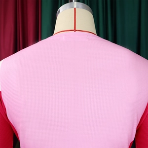 Detail of pink waffle texture fabric with red stitching and breathable mesh design