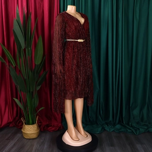 Detail of elegant burgundy shimmering dress featuring V-neckline and gold buckle belt