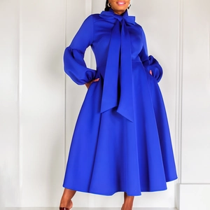 Detail of royal blue midi dress with oversized bow tie neck and puff lantern sleeves