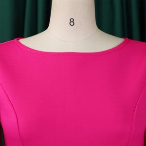 Close-up of elegant rose red dress showing refined boat neck design and premium fabric