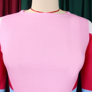 Detail of color block long sleeve top with breathable mesh texture on a mannequin