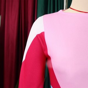 Macro shot of breathable honeycomb mesh fabric on pink color block long sleeve sports top
