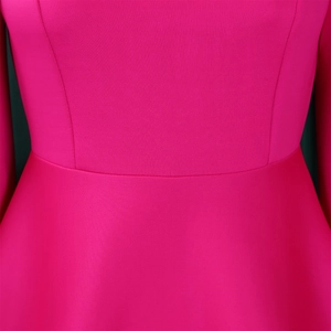 Detailed close-up of the waist stitching and fuchsia fabric on this elegant evening dress