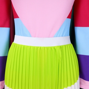 Close-up of color-block pleated skirt waist featuring vibrant pink and green fabrics