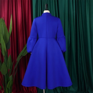 Detailed view of royal blue lantern sleeves and high waist design on this A-line dress