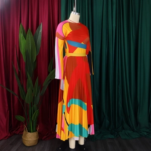 Detail of colorful geometric print and pleated skirt texture on a long sleeve dress