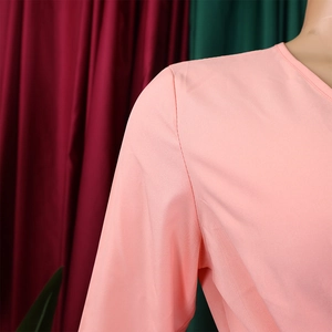 Detail shot of the V-neckline and pleat texture on this elegant light pink dress