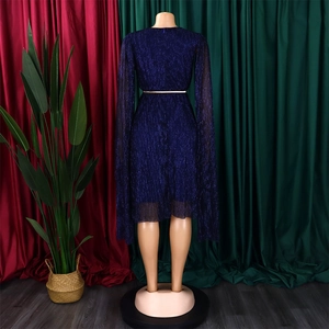 Macro detail of royal blue evening dress with metallic threads and a gold belt
