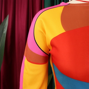 Close-up of vibrant mesh fabric showing detailed stitching and colorful abstract patterns