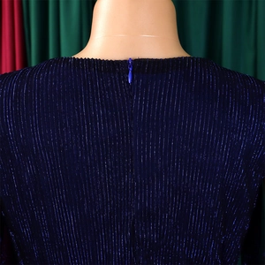 Detail of invisible zipper on V-neck dress with dark blue metallic pleated fabric texture