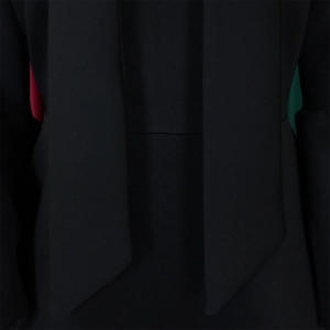 Detailed close-up of a black lantern sleeve dress neckline with red and turquoise lining