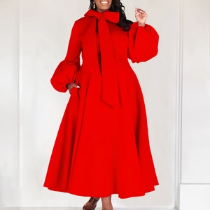Detail of red gown showing a large bow neckline and dramatic puff sleeve design