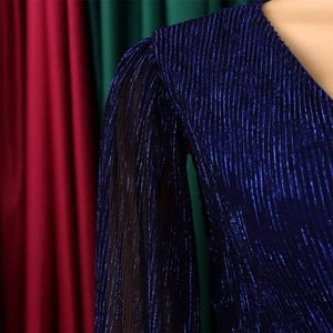 Detail of royal blue pleated fabric with metallic luster and V-neckline design