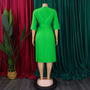 Detail view of the pleated back design and hidden zipper on this bright green midi dress