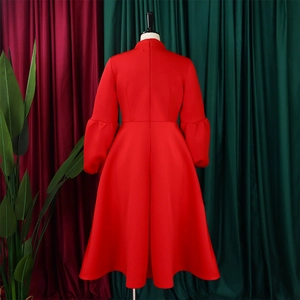 Detail of red lantern sleeves and high-waist bow on a stylish A-line party dress