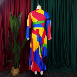 Detail of colorful geometric print long sleeve dress with elegant pleated hem design