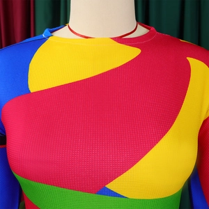Detail of color-block knitted top featuring vibrant geometric patterns and mesh texture