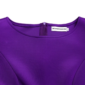 Detail view of purple dress neckline with hidden zipper and Metamorphosis Girl label